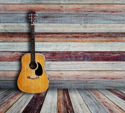 The Rockabilly guitar sits in the corner without anyone playing it.